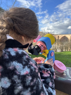 A child looking through the Lumi astronomical refractor
